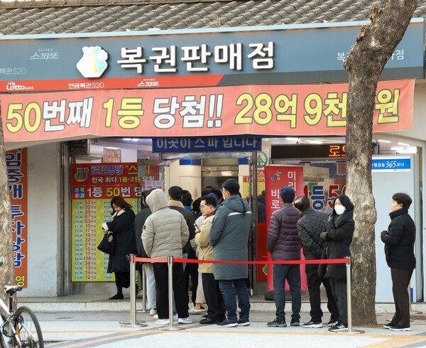 서울 노원구의 한 복권 가게 앞, 사람들이 복권을 사기 위해 줄을 서고 있다. 청룡의 좋은 기운을 받아 일등 당첨을 꿈꾸는 사람들이 가득하다.